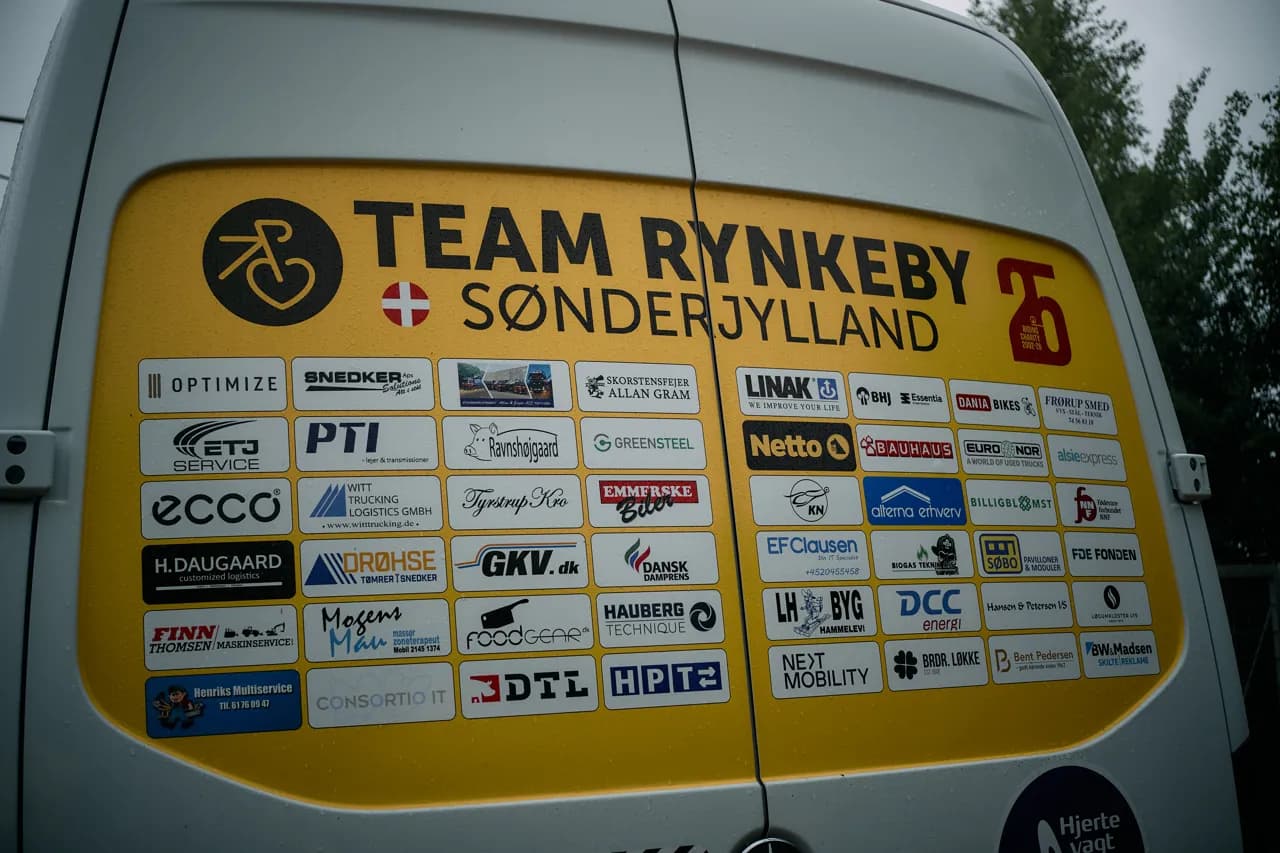 The back of a Team Rynkeby support van covered in local sponsor logos