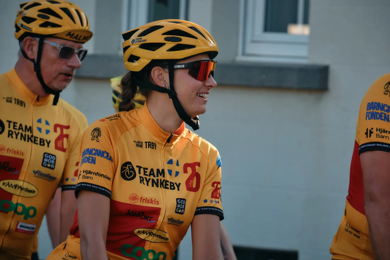Close-up of Team Rynkeby jerseys covered in sponsor logos